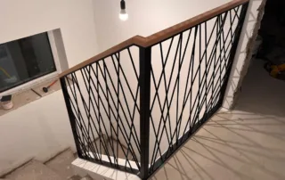 Spaghetti-Treppengeländer schwarz mit Holzhandlauf